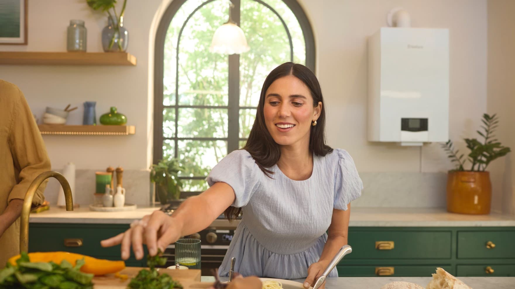 Mujer en una cocina delante de una caldera