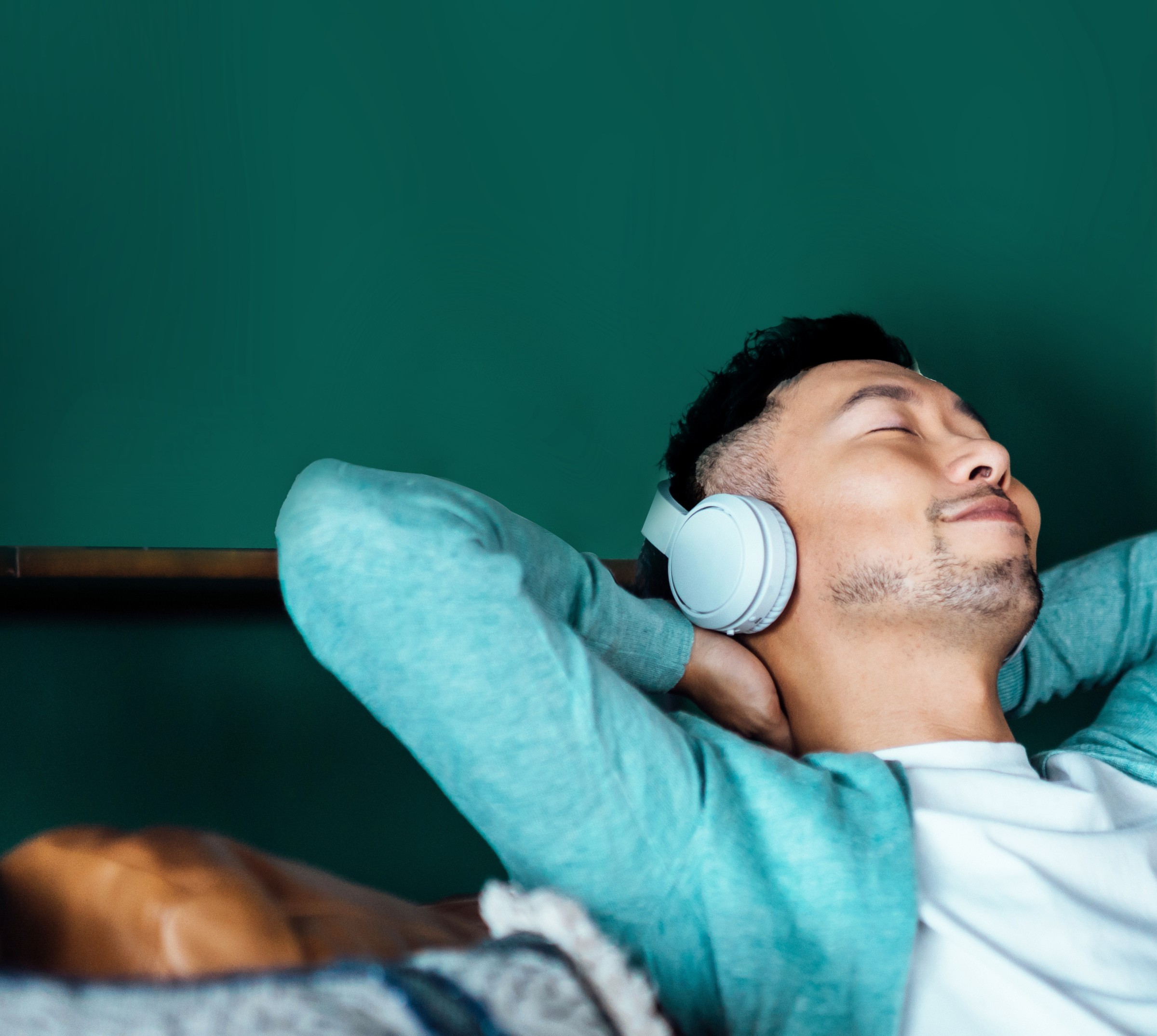 Man with headphones on couch