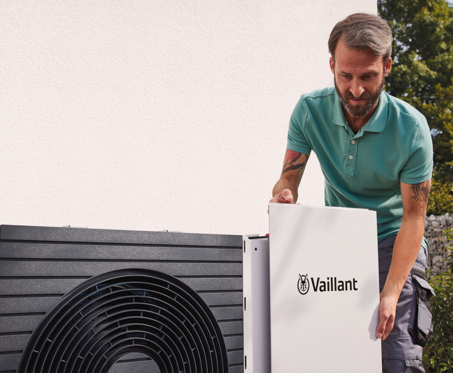 installer working on outdoor unit of heat pump